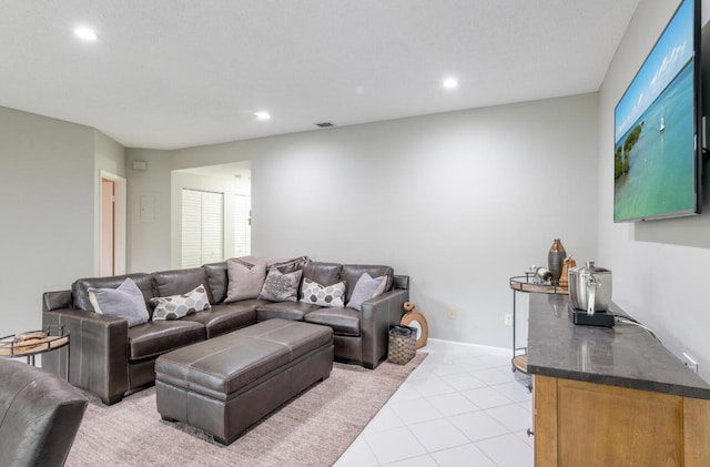 living area featuring recessed lighting, visible vents, baseboards, and light tile patterned flooring