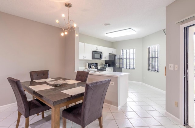 dining space featuring visible vents, a textured ceiling, light tile patterned floors, baseboards, and a chandelier