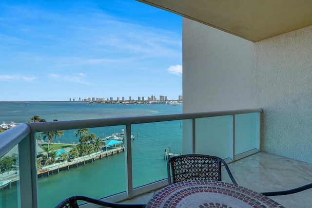 balcony with a water view and a city view