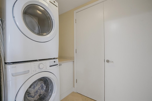 2650 Lake Shore Dr Unit 703, Riviera Beach, FL 33404 - laundry room featuring stacked washer / drying machine and cabinet space