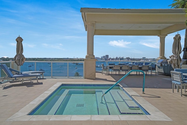 2650 Lake Shore Dr Unit 703, Riviera Beach, FL 33404 - view of swimming pool featuring a water view, a pool, and a patio