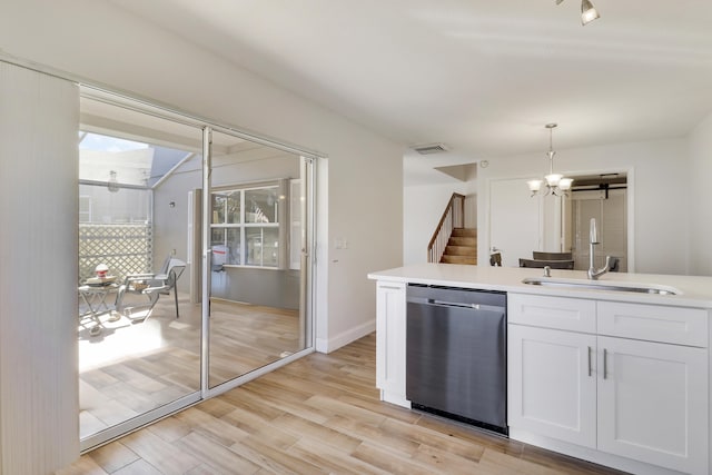 kitchen featuring a chandelier, dishwasher, light wood-style floors, white cabinets, and a sink