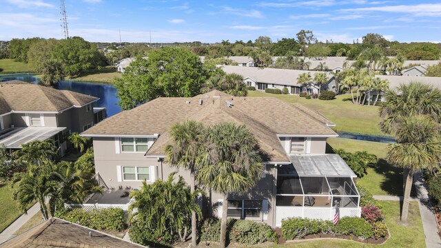 drone / aerial view with a residential view and a water view