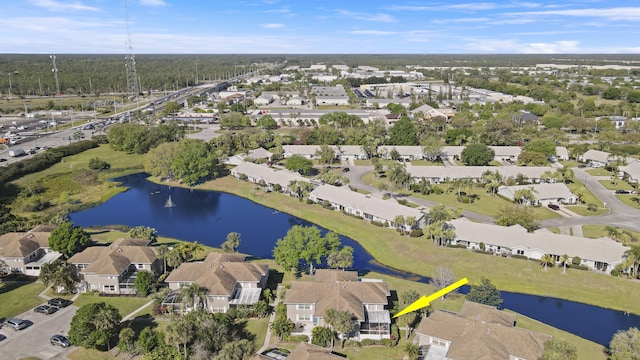 drone / aerial view featuring a residential view and a water view