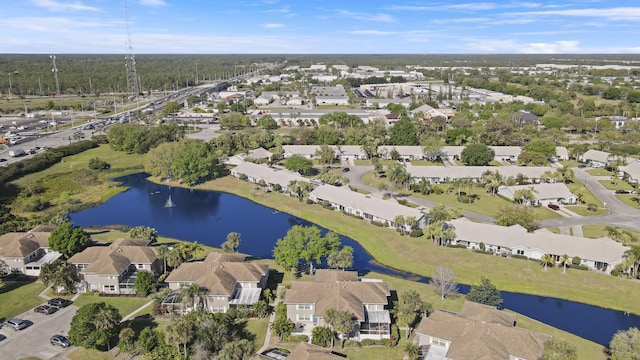 drone / aerial view featuring a residential view and a water view