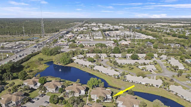 drone / aerial view with a residential view and a water view