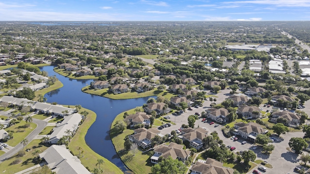 drone / aerial view with a residential view and a water view