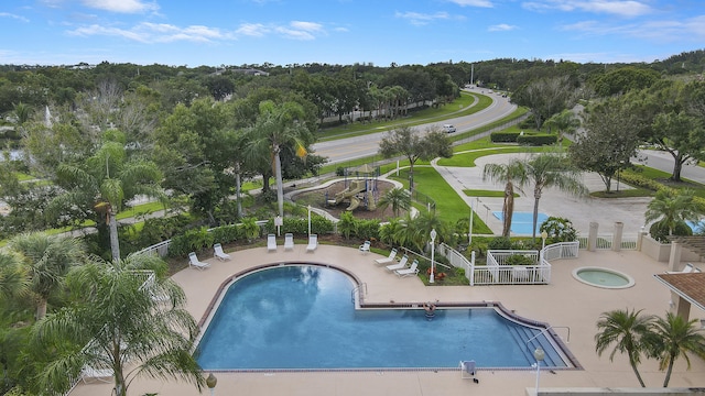 pool with a patio area and fence