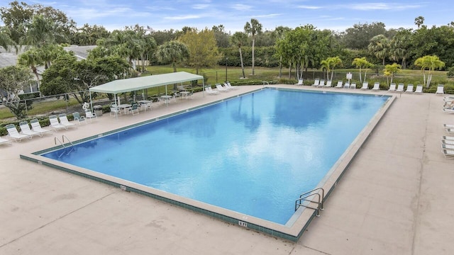 community pool featuring a patio and fence