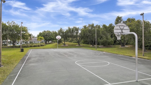 view of sport court with a lawn and community basketball court