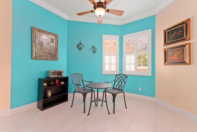 dining space with tile patterned flooring, a ceiling fan, baseboards, and ornamental molding