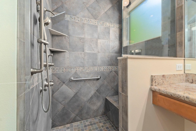 bathroom with walk in shower and vanity