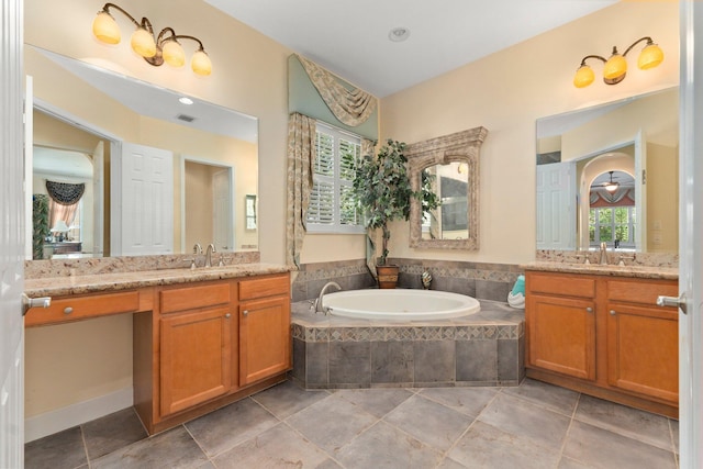 bathroom featuring a sink, visible vents, two vanities, and a bath