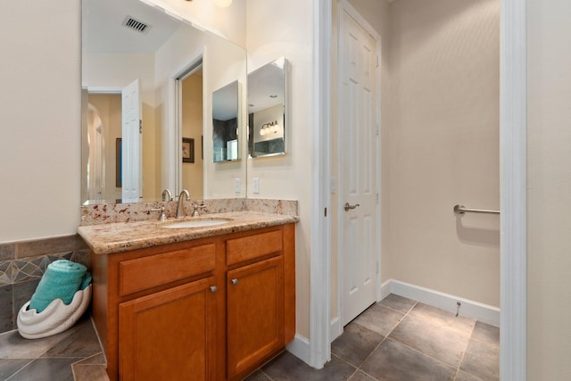 bathroom with visible vents, baseboards, and vanity