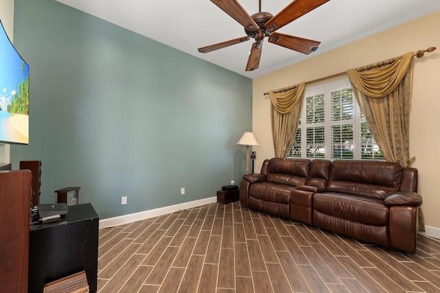 living room featuring baseboards, a ceiling fan, and wood tiled floor