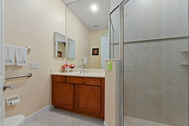 bathroom with tile patterned flooring, a shower stall, toilet, and vanity