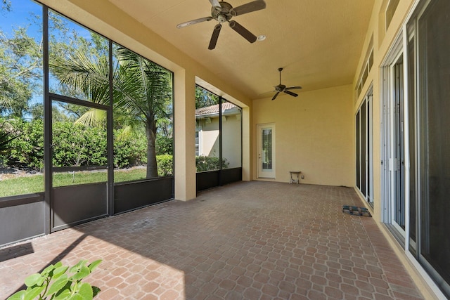 unfurnished sunroom with a ceiling fan