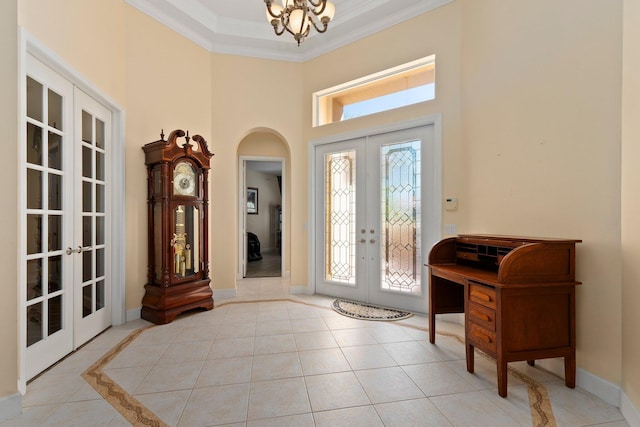 foyer featuring french doors, light tile patterned flooring, crown molding, baseboards, and a chandelier