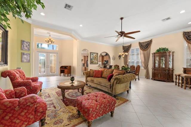 living area with arched walkways, visible vents, and ornamental molding