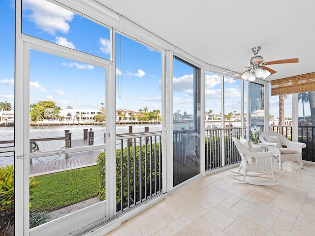 unfurnished sunroom with a ceiling fan