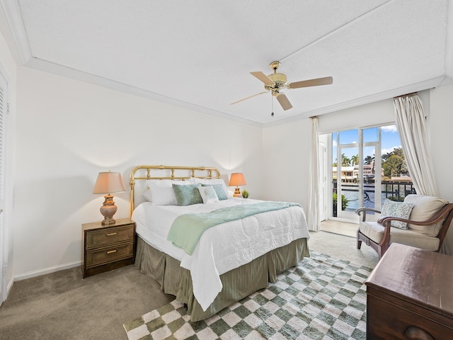 bedroom with access to exterior, baseboards, carpet, ornamental molding, and a ceiling fan