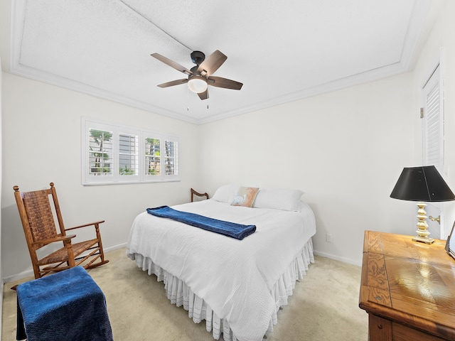 bedroom featuring light carpet, a ceiling fan, baseboards, and ornamental molding