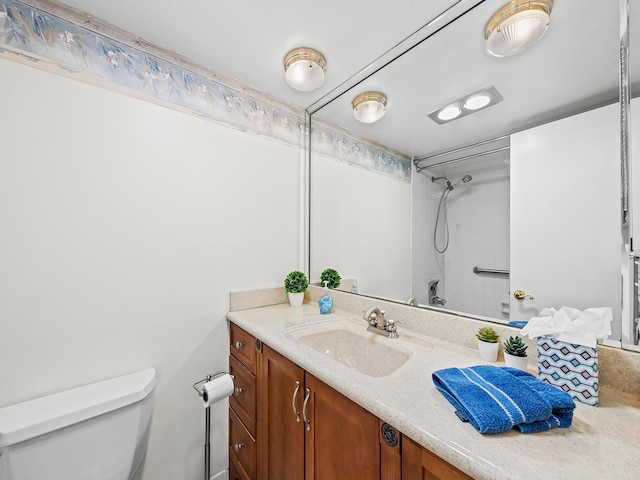 full bath with vanity, toilet, and walk in shower