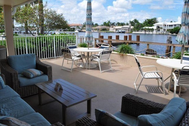 view of patio featuring outdoor dining space, an outdoor living space, and a water view