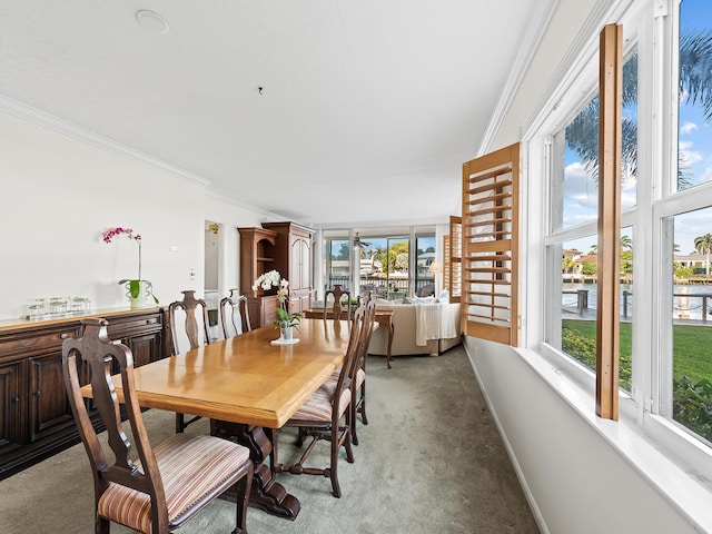 dining space with carpet, baseboards, and ornamental molding