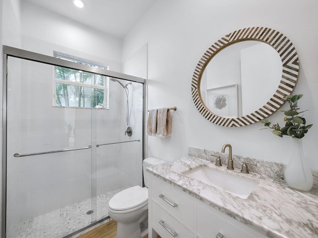 full bathroom with toilet, recessed lighting, wood finished floors, a shower stall, and vanity