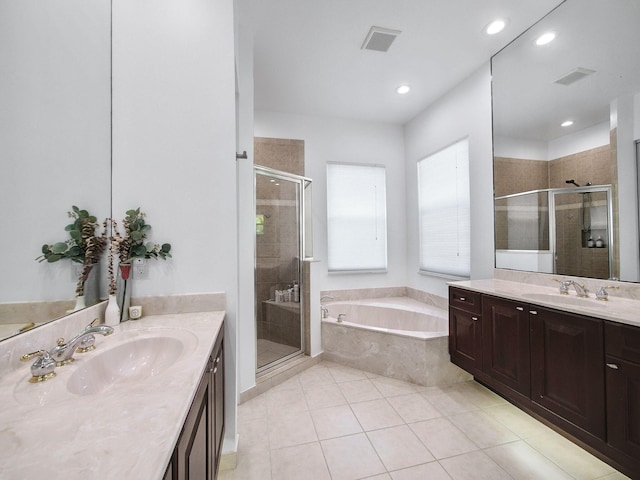 bathroom featuring a garden tub, visible vents, a sink, and a stall shower