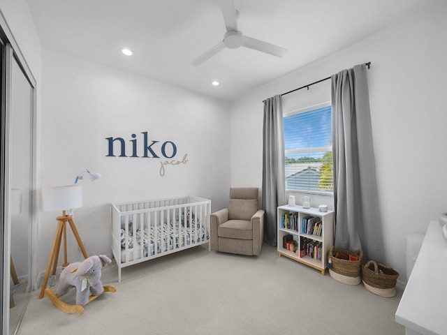 bedroom featuring carpet flooring, recessed lighting, a ceiling fan, a closet, and a nursery area