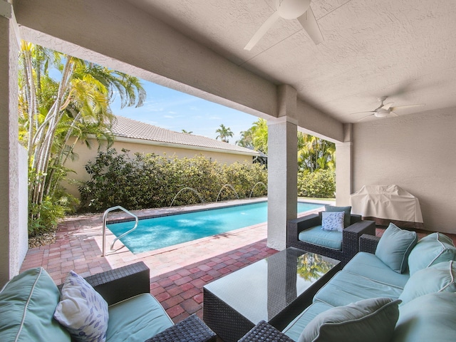 outdoor pool featuring an outdoor living space, ceiling fan, and a patio