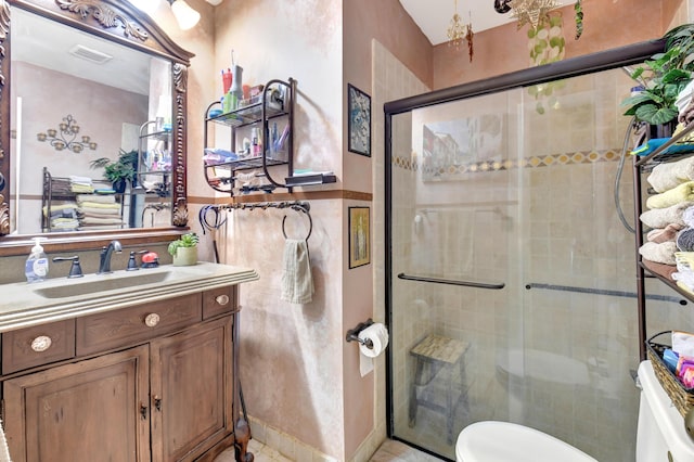 full bath with visible vents, vanity, toilet, and a shower stall