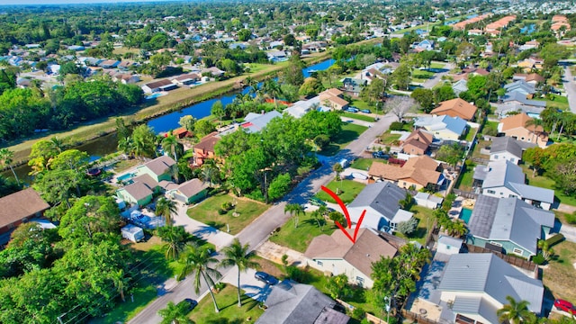 birds eye view of property with a residential view and a water view