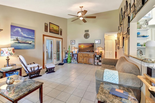 living area with light tile patterned floors, a ceiling fan, visible vents, high vaulted ceiling, and french doors