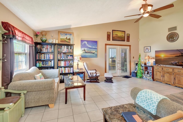 living room with visible vents, ceiling fan, light tile patterned floors, french doors, and high vaulted ceiling