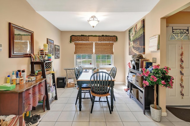 dining room with light tile patterned floors and baseboards