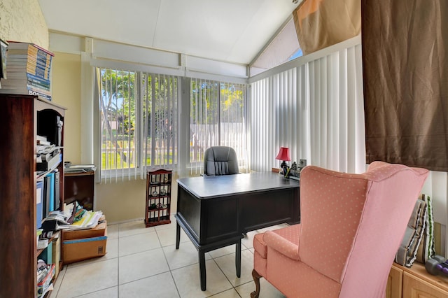 office space featuring tile patterned floors and vaulted ceiling