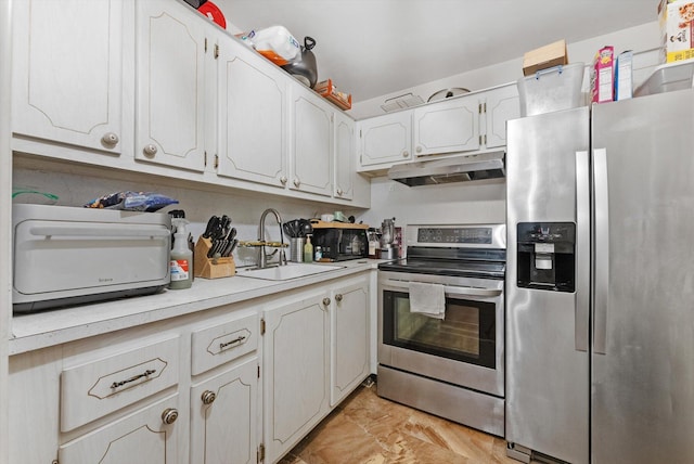 kitchen featuring under cabinet range hood, a sink, appliances with stainless steel finishes, white cabinets, and light countertops