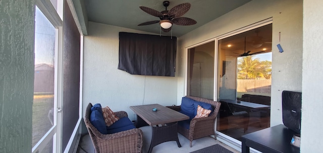 sunroom featuring a ceiling fan