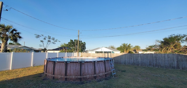 view of yard with a fenced in pool and a fenced backyard