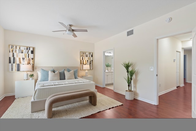 826 Dakota Dr Unit 105, Jupiter, FL 33458 - bedroom with dark wood-type flooring, baseboards, connected bathroom, and ceiling fan
