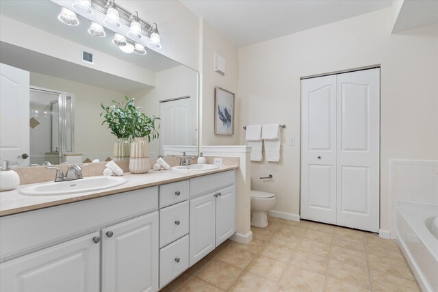826 Dakota Dr Unit 105, Jupiter, FL 33458 - full bath with a stall shower, toilet, double vanity, a garden tub, and tile patterned flooring