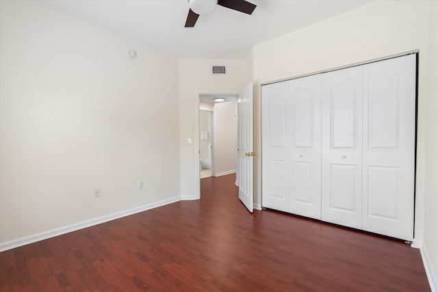 826 Dakota Dr Unit 105, Jupiter, FL 33458 - unfurnished bedroom with dark wood-style floors, baseboards, a closet, and ceiling fan