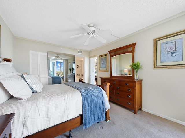 bedroom with visible vents, baseboards, light colored carpet, a textured ceiling, and a ceiling fan
