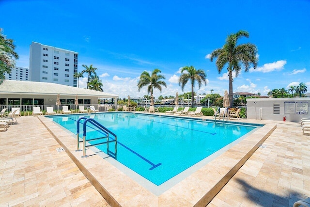 community pool featuring a patio and fence