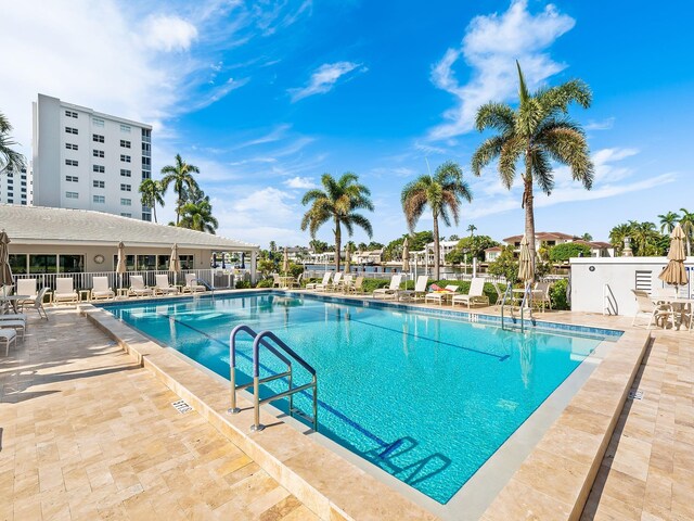 pool featuring a patio area and fence
