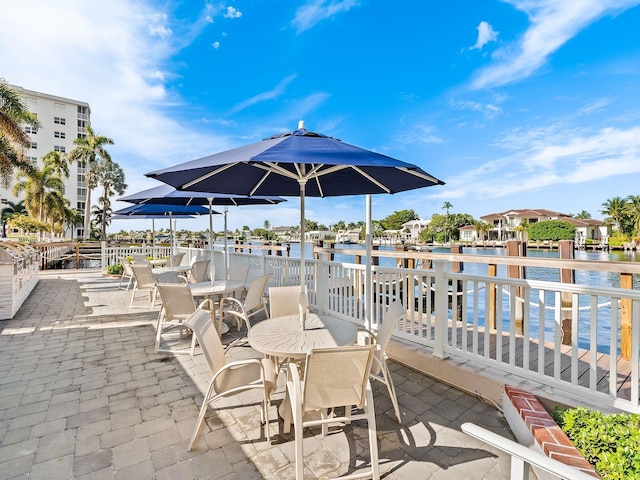 view of patio / terrace featuring outdoor dining area and a water view