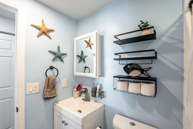 half bathroom with toilet and vanity